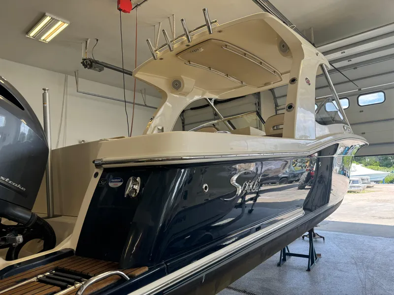 Slide: The Image of 2014 Scout 275 Dorado boat in a garage, side view. - 5