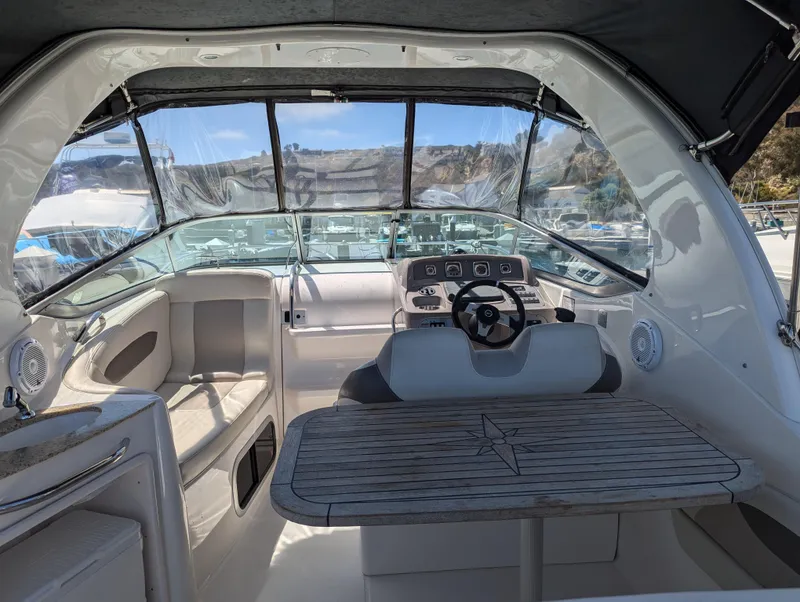 Slide: The Image of Interior cockpit of a 2011 Chaparral Signature 270 boat with steering wheel and seating. - 25