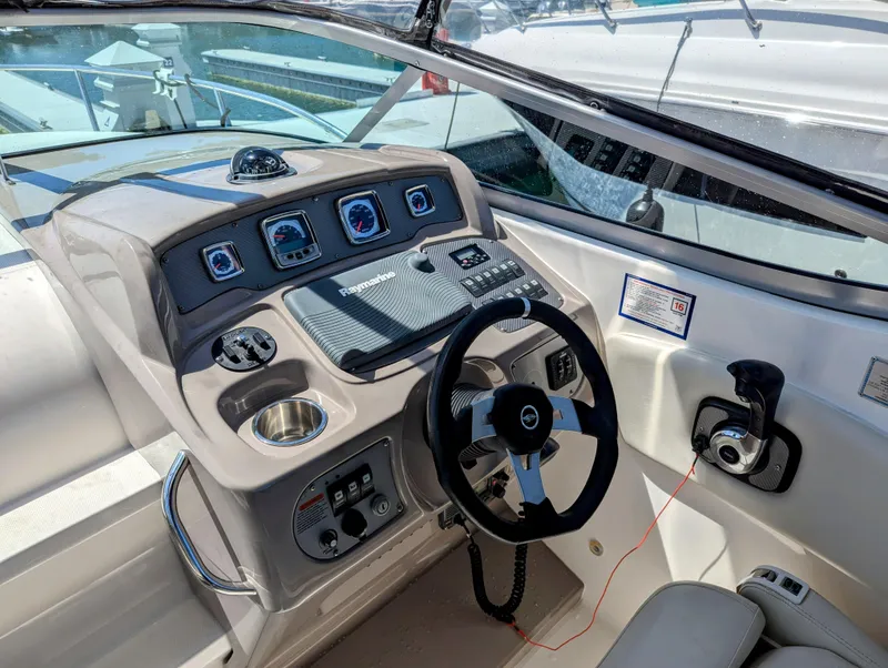 Slide: The Image of 2011 Chaparral Signature 270 boat helm with steering wheel and control panel. - 26