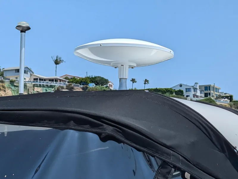 Slide: The Image of 2011 Chaparral Signature 270 radar dome and black canvas top with coastal homes in background. - 40