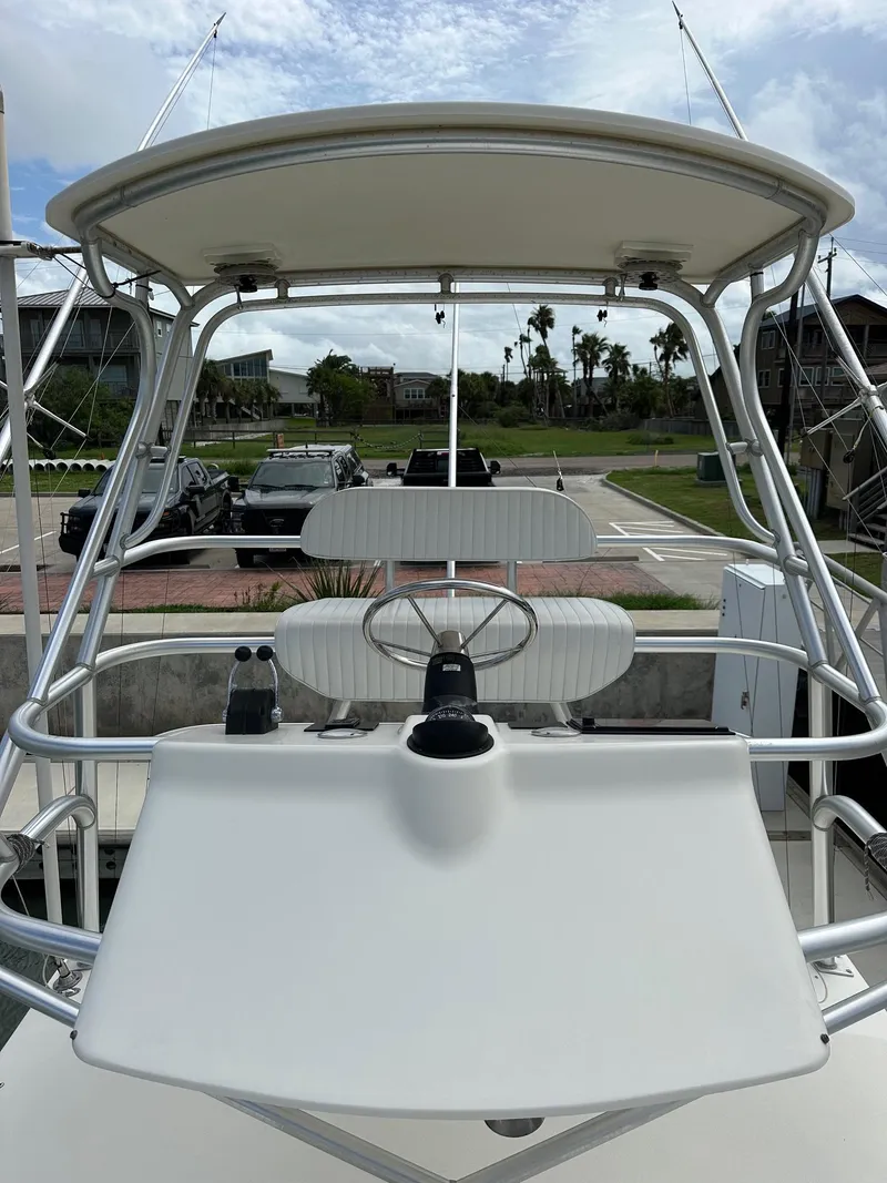 Slide: The Image of 2006 Albemarle 320 Express Fisherman boat interior with seating and helm station. - 11