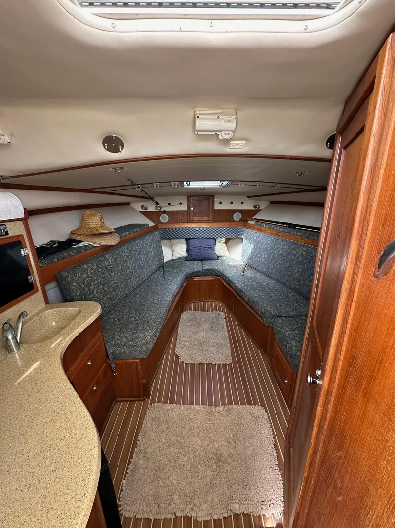 Slide: The Image of Helm of 2006 Albemarle 320 Express Fisherman at dock, featuring steering wheel and navigation equipment. - 12