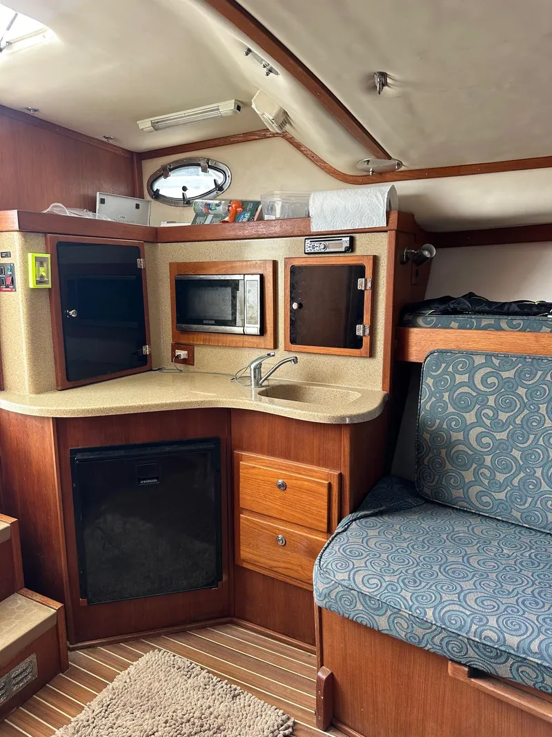 Slide: The Image of 2006 Albemarle 320 Express Fisherman boat with a white helm station and canopy. - 14