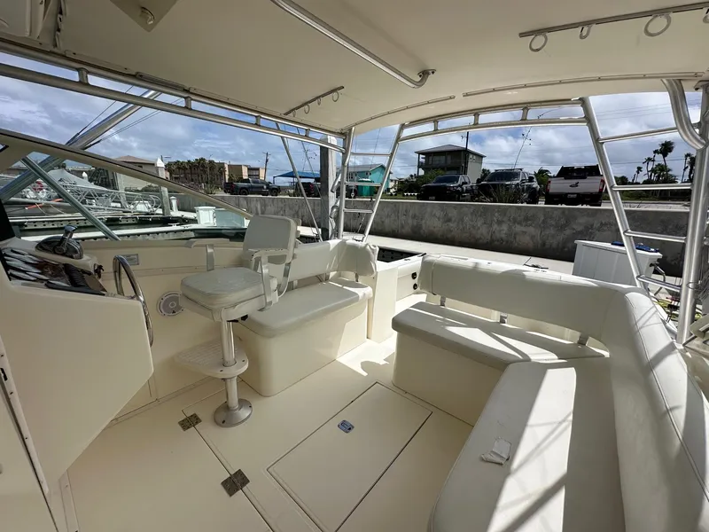 Slide: The Image of 2006 Albemarle 320 Express Fisherman boat docked, showing spacious deck and storage compartments. - 8