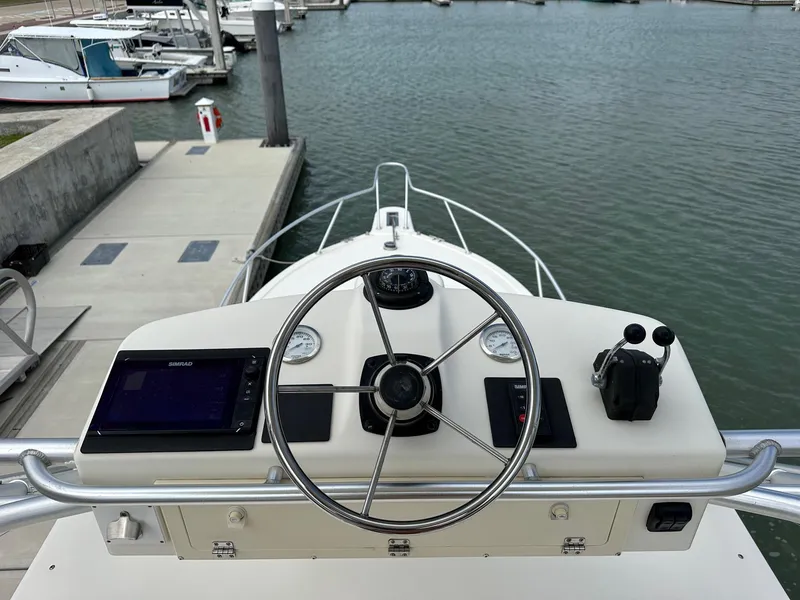 Slide: The Image of 2006 Albemarle 320 Express Fisherman boat interior with helm station and seating. - 9