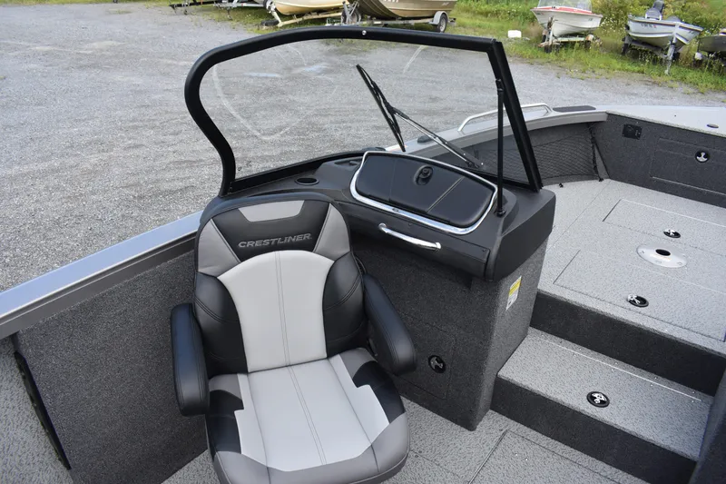 Slide: The Image of 2023 Crestliner 2250 Authority boat interior with captain's chair and windshield. - 16