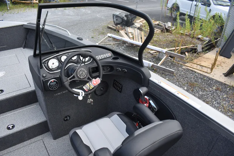 Slide: The Image of 2023 Crestliner 2250 Authority boat cockpit with steering wheel and control panel. - 17