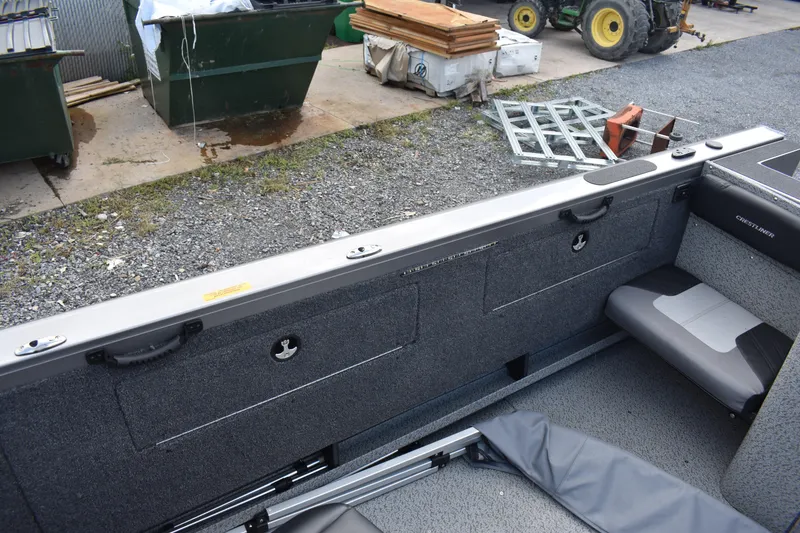 Slide: The Image of 2023 Crestliner 2250 Authority boat interior with storage compartments and seating. - 19