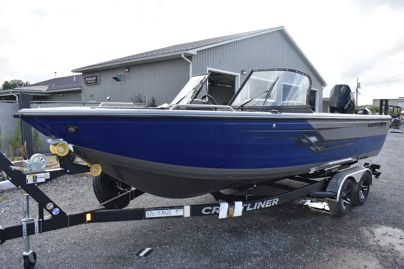 Slide: The Image of 2023 Crestliner 2250 Authority boat on trailer, blue and black exterior. - 5