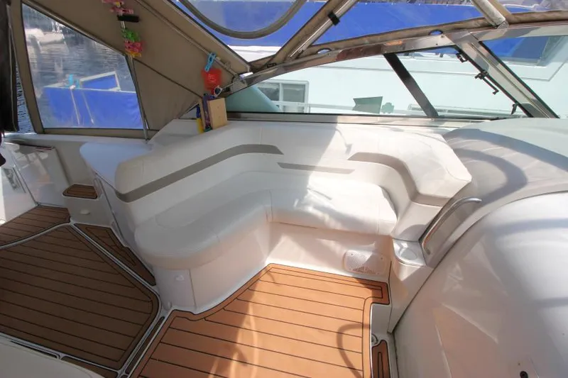 Slide: The Image of Interior seating area of a 2001 Formula 41 PC yacht with white cushions and wooden flooring. - 11