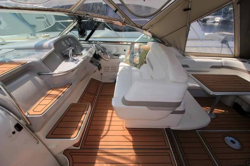 Slide: The Image of 2001 Formula 41 PC boat interior with white seating and wooden flooring. - 12