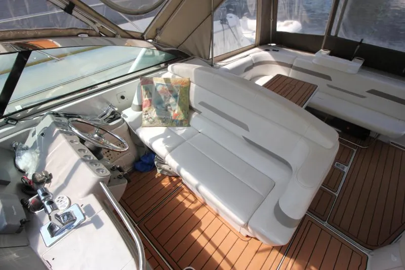 Slide: The Image of 2001 Formula 41 PC boat interior with white seating and wooden flooring. - 13