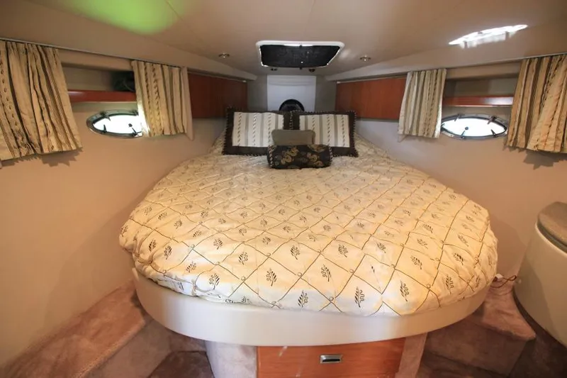 Slide: The Image of 2001 Formula 41 PC boat interior bedroom with cozy bed and porthole windows. - 17