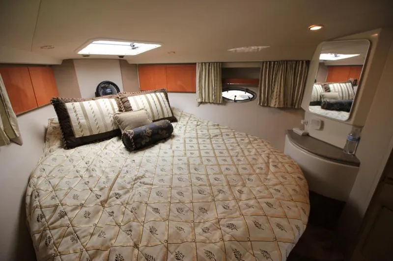 Slide: The Image of Luxurious bedroom in a 2001 Formula 41 PC yacht with a cozy bed and elegant decor. - 18