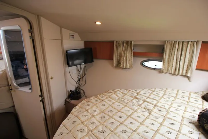 Slide: The Image of 2001 Formula 41 PC boat cabin with bed, TV, and porthole window. - 19