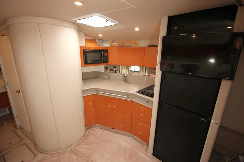 Slide: The Image of 2001 Formula 41 PC yacht interior kitchen with microwave, fridge, and TV. - 22