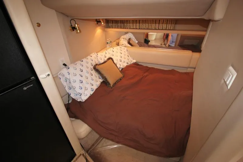 Slide: The Image of Cozy bedroom in 2001 Formula 41 PC yacht with brown bedding and decorative pillows. - 26