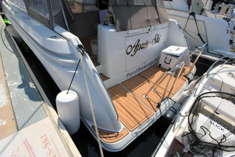 Slide: The Image of 2001 Formula 41 PC yacht docked, featuring teak swim platform and Après-Ski name on the stern. - 5