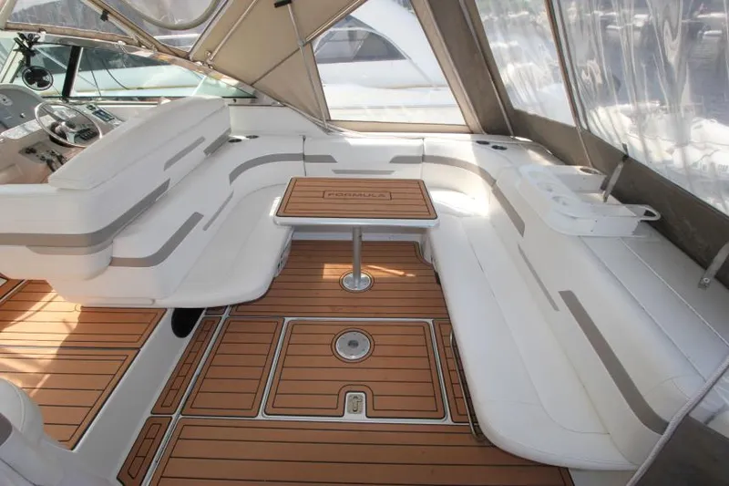 Slide: The Image of 2001 Formula 41 PC yacht interior with white seating and wooden flooring. - 8