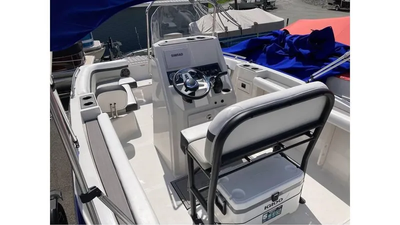 Slide: The Image of 2024 Starcraft SVX 191 OB CC boat interior with steering console and seating. - 8