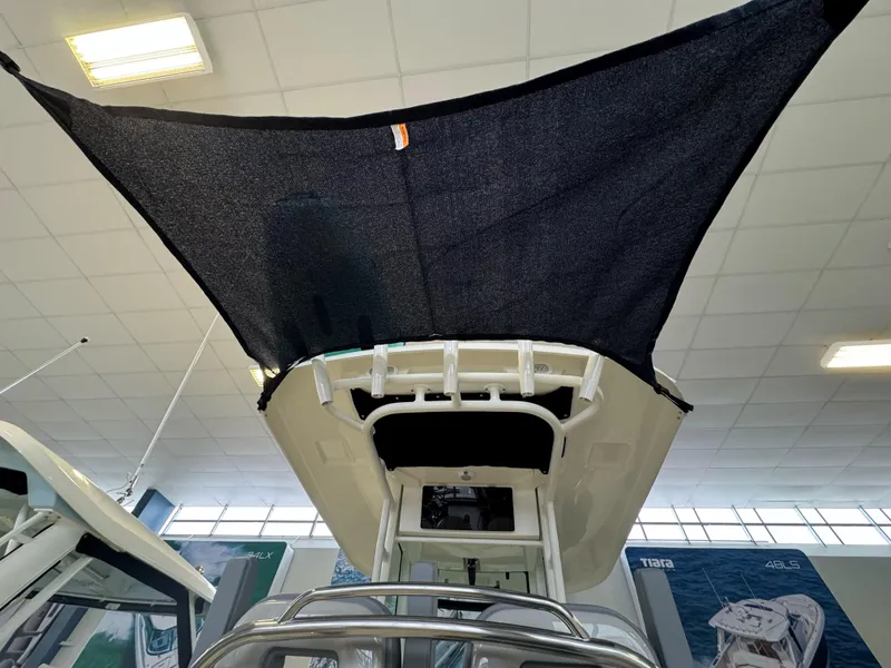 Slide: The Image of 2025 Boston Whaler 250 Outrage boat with sunshade canopy in showroom. - 11