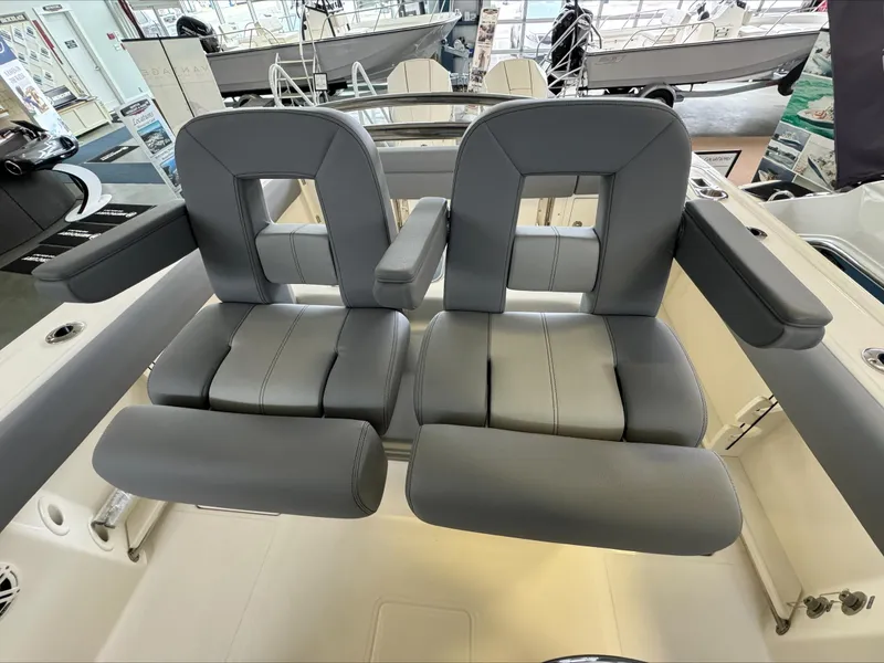 Slide: The Image of 2025 Boston Whaler 250 Outrage boat seats, featuring luxurious gray upholstery and ergonomic design. - 16