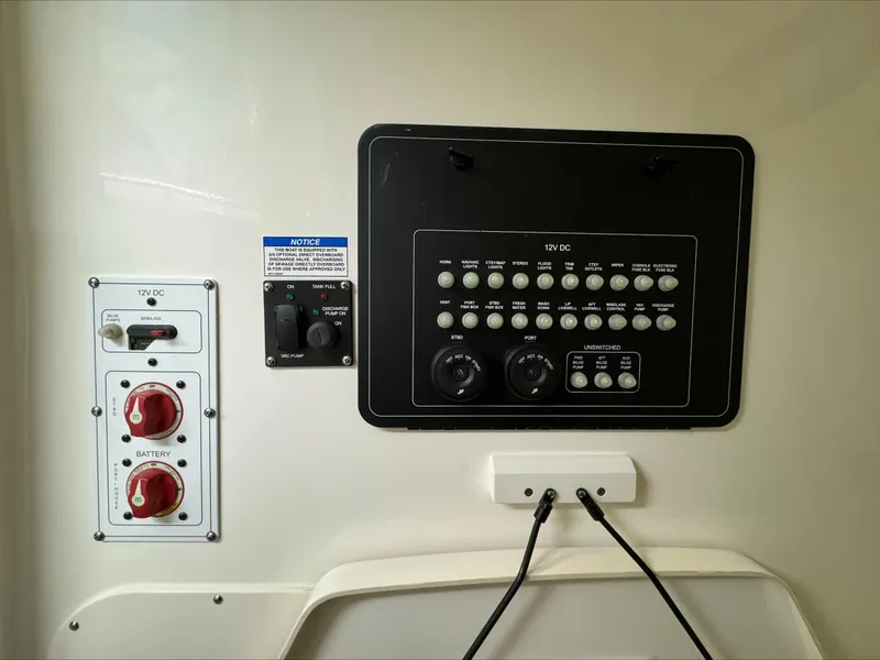 Slide: The Image of 2025 Boston Whaler 250 Outrage control panel with switches and battery controls. - 21
