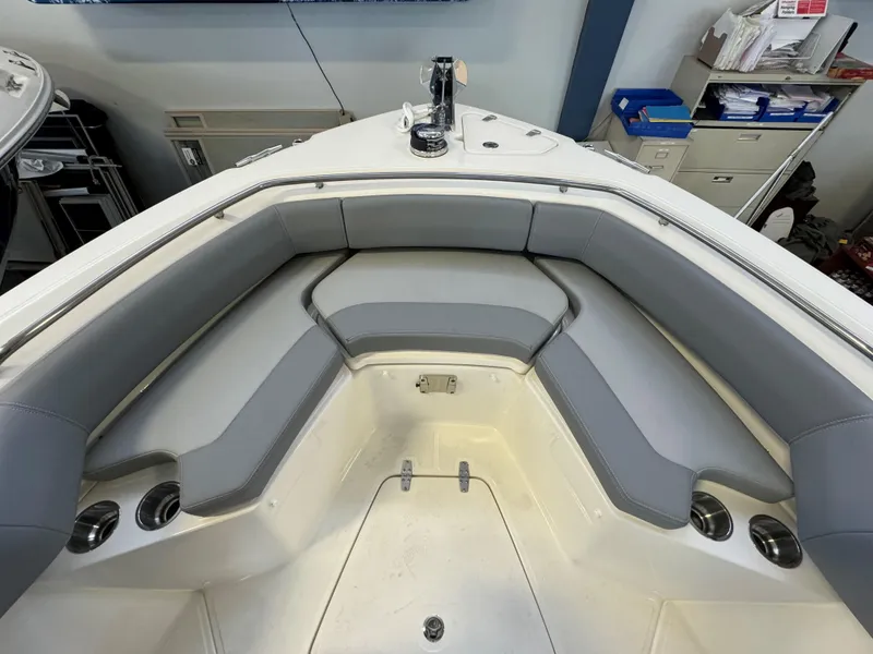 Slide: The Image of 2025 Boston Whaler 250 Outrage boat interior with gray cushioned seating. - 24