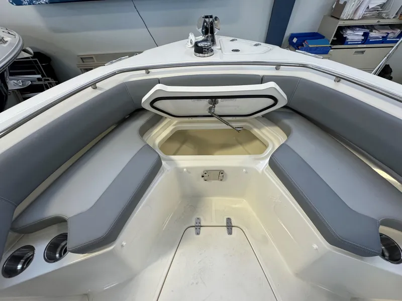 Slide: The Image of 2025 Boston Whaler 250 Outrage boat interior with gray seating and storage compartment. - 25