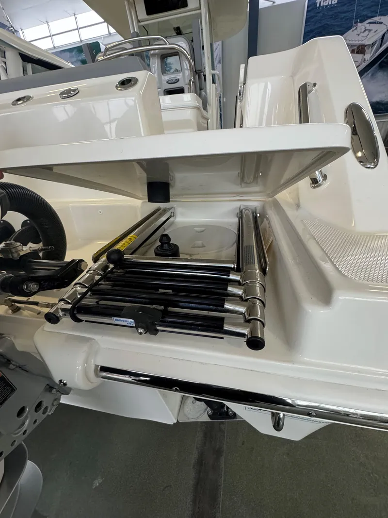 Slide: The Image of 2025 Boston Whaler 250 Outrage boat with open storage compartment and ladder. - 5