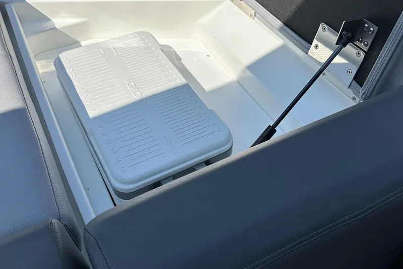 Slide: The Image of 2024 Cobalt CS22 boat storage compartment with a white cooler. - 14