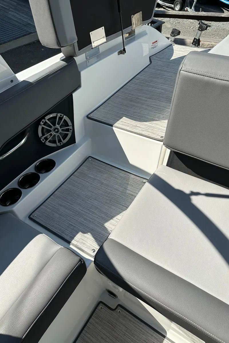 Slide: The Image of 2024 Cobalt CS22 boat interior with gray seating and cup holders. - 15