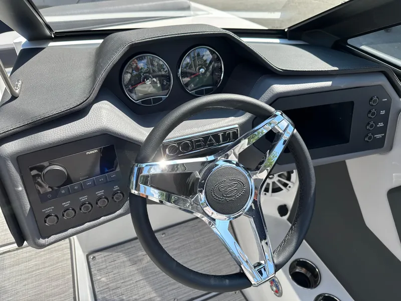 Slide: The Image of 2024 Cobalt CS22 boat dashboard with chrome steering wheel and modern controls. - 5