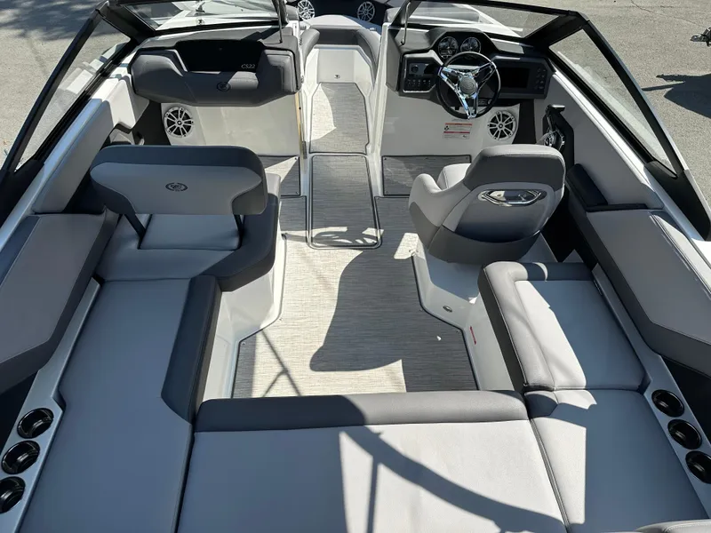 Slide: The Image of 2024 Cobalt CS22 boat interior with modern seating and steering console. - 9
