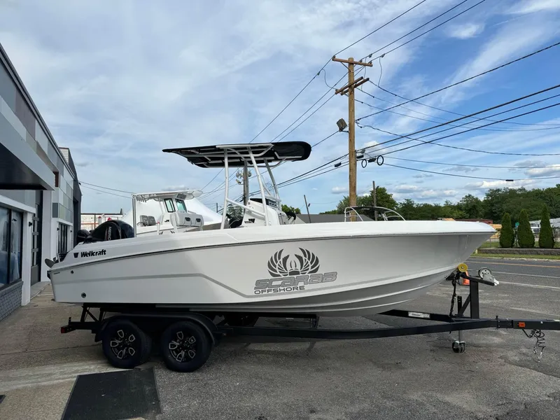 The Image of 2025 Wellcraft 202 Fisherman boat on a trailer, parked outdoors. - 0