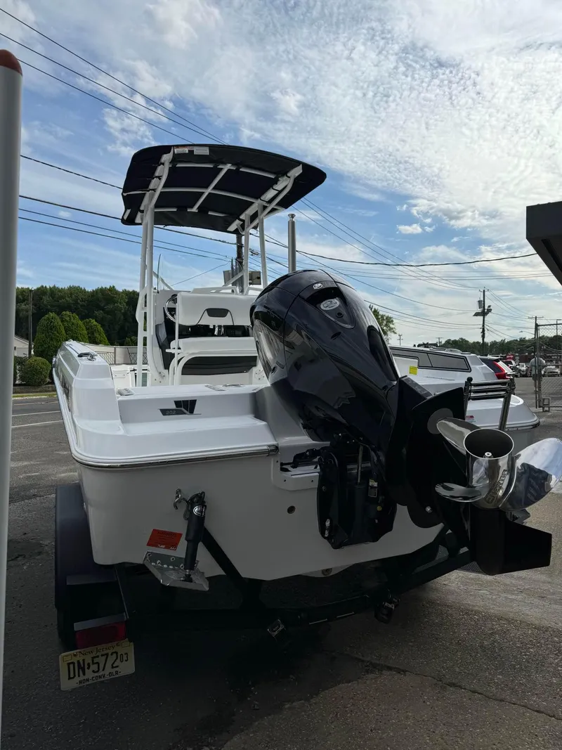 Slide: The Image of 2025 Wellcraft 202 Fisherman boat with outboard motor, rear view. - 5