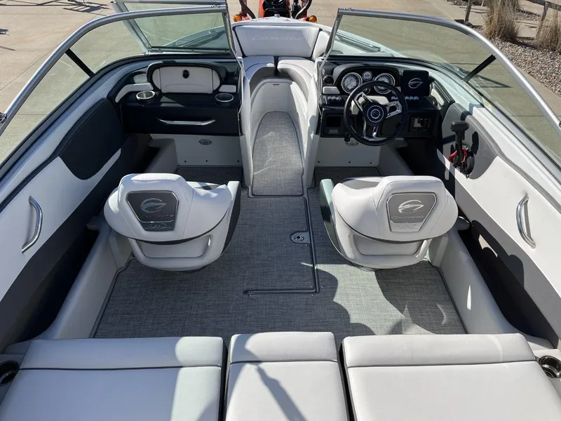 Slide: The Image of 2023 Crownline 210SS boat interior with modern seating and dashboard. - 10