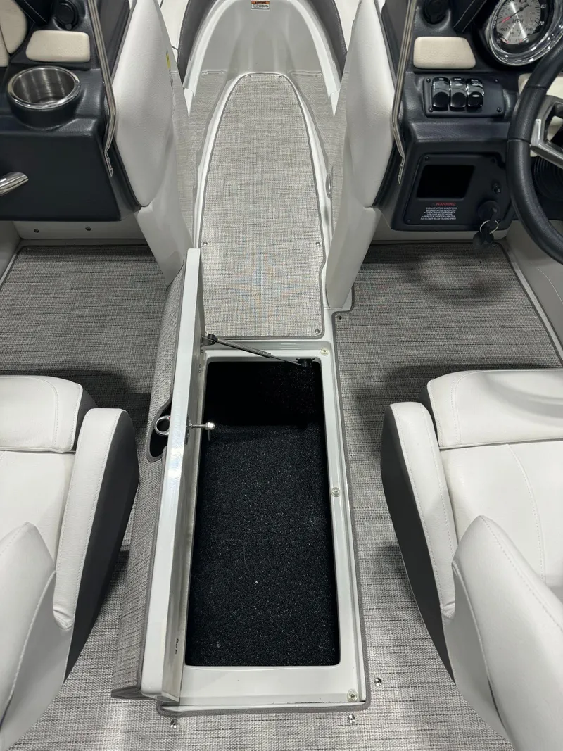 Slide: The Image of 2023 Crownline 210SS boat interior with open storage compartment. - 11