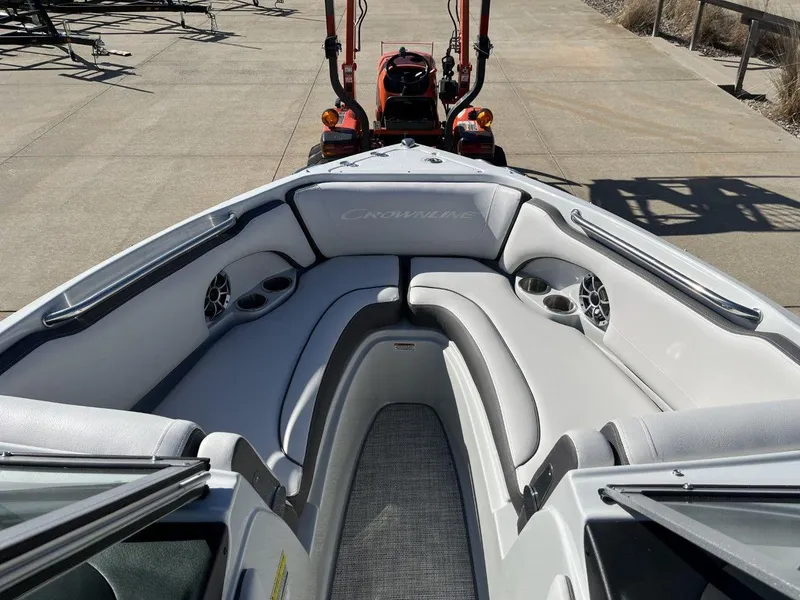 Slide: The Image of 2023 Crownline 210SS boat interior with cushioned seating and cup holders. - 4