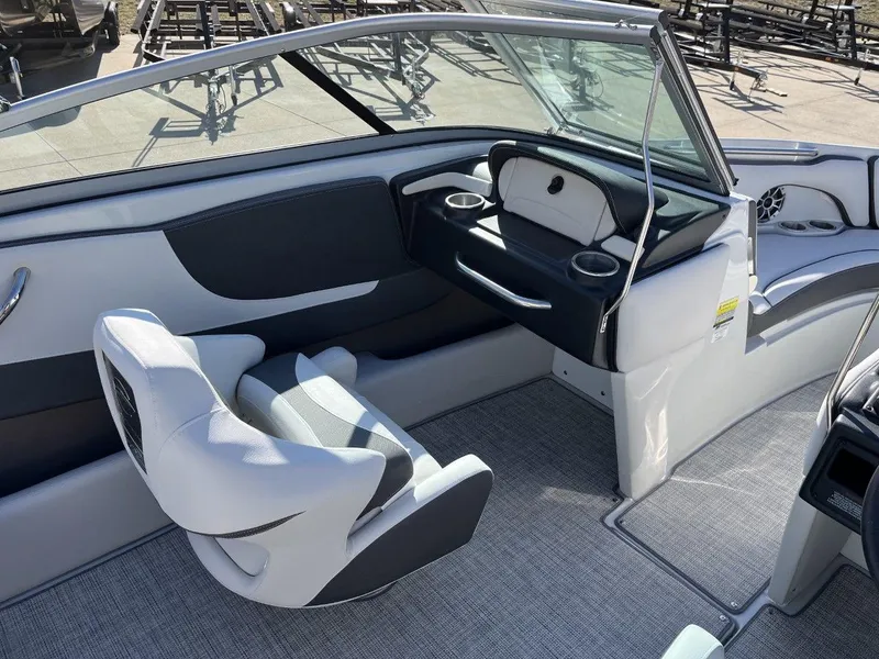 Slide: The Image of 2023 Crownline 210SS boat interior with modern seating and dashboard. - 5