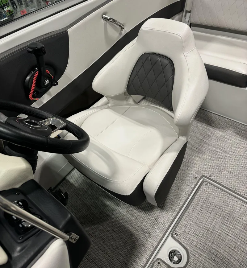 Slide: The Image of 2023 Crownline 210SS boat interior with white and black captain's seat. - 8