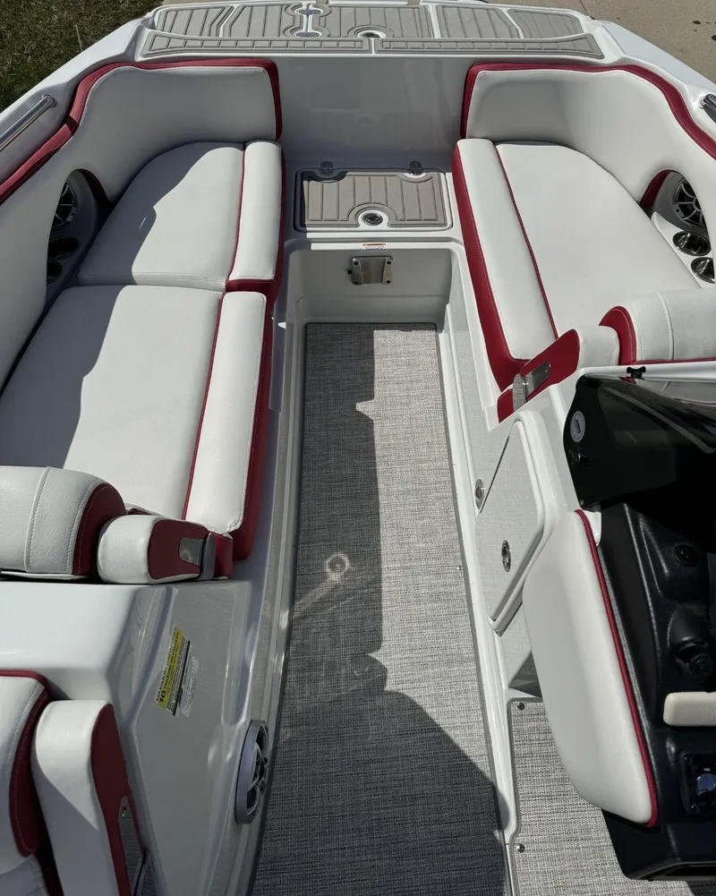 Slide: The Image of 2023 Crownline E205 XS boat interior with white and red seating. - 10
