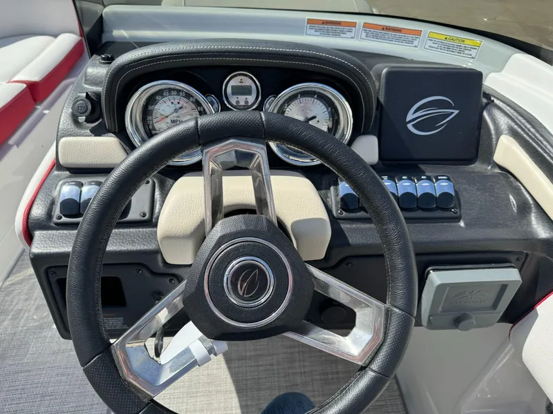 Slide: The Image of 2023 Crownline E205 xs boat dashboard with steering wheel and instrument panel. - 11