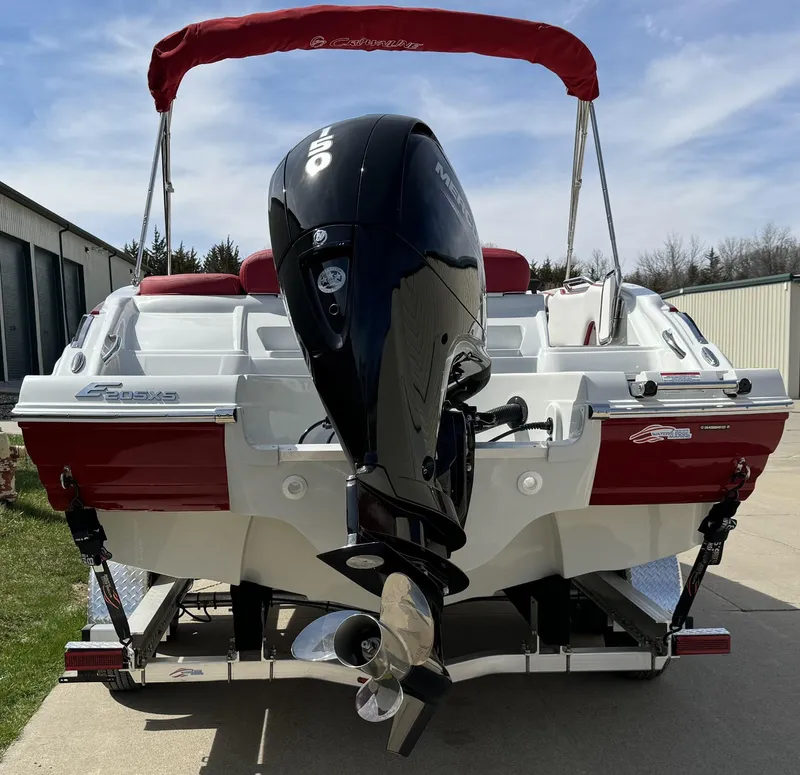 Slide: The Image of 2023 Crownline E205 XS boat with outboard motor and red canopy. - 4