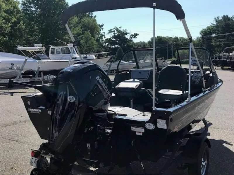 Slide: The Image of 2024 Tracker Pro Guide™ V-16 WT boat with Mercury engine in a marina. - 3