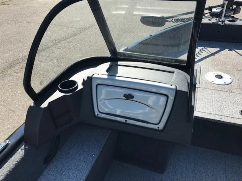 Slide: The Image of 2024 Tracker Pro Guide™ V-16 WT boat interior with windshield and storage compartment. - 9