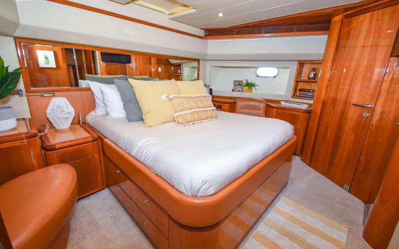 Slide: The Image of Luxurious 2006 Ferretti Yachts 881 bedroom with elegant wood finish and plush bedding. - 10