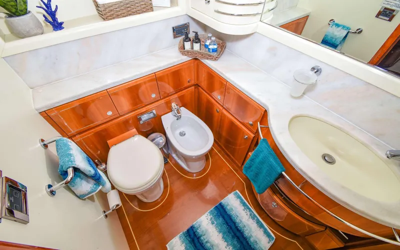 Slide: The Image of Luxurious bathroom in 2006 Ferretti Yachts 881, featuring elegant wood cabinetry and modern fixtures. - 11