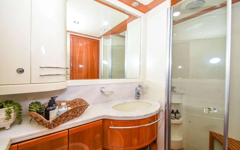 Slide: The Image of Luxurious bathroom in 2006 Ferretti Yachts 881 with modern fixtures and elegant wood accents. - 13