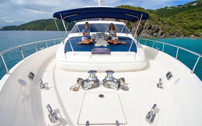 Slide: The Image of 2006 Ferretti Yachts 881 on scenic ocean cruise with two people relaxing on deck. - 2
